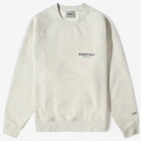 The Fear of God Essentials Long Sleeve Polo Sweatshirt in gray showcases subtle printed text on the front and sleeve. It features a crew neck and long sleeves, displayed against a plain white background.