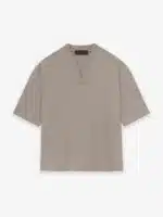 The Fear of God Essentials V-Neck T-Shirt 'Core Heather', featuring a plain beige design with short sleeves, is displayed on a white background.