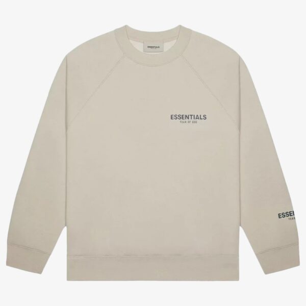 A beige Fear of God Essentials Core Crew Sweatshirt featuring "ESSENTIALS Fear of God" printed in black on the upper left chest and right sleeve, displayed on a plain white background.