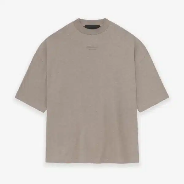 The Fear of God Essentials T-Shirt 'Core Heather' is an oversized beige t-shirt featuring short sleeves and a crew neckline, showcased against a white background.