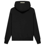 Fear of God Essentials Pullover Hoodie 'Black' features a hooded design, shown from the back, with long sleeves and ribbed cuffs. A rectangular label or patch is prominently displayed at the top center of the back.