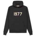 Fear of God 1977 Essentials Hoodie 'Off-Black' featuring a front pocket and large beige numbers 1977 on the chest.