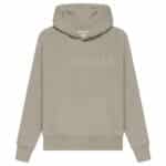 The Fear of God Essentials Pullover Hoodie 'Core-Heather' is a beige hoodie featuring ESSENTIALS and FEAR OF GOD embroidered on the front. It includes a front pocket and a hood, displayed against a plain white background.