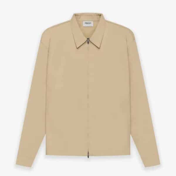 A khaki, long-sleeve Fear of God ESSENTIALS Twill Jacket featuring a collar and a front zipper, displayed against a white background.