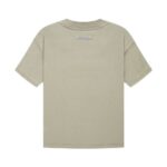 Back view of a plain, light grey Fear of God Essentials T-shirt with a subtle rectangular label on the upper back. The shirt features short sleeves and a simple round neckline.