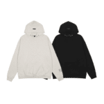 Side by side, two hoodies are laid flat with sleeves extended: one is the Fear of God Essentials FG7C Hoodie in 'Light-Oatmeal' and the other is black. Both feature a front pocket. The 'Light-Oatmeal' hoodie has an FG logo on the sleeve, while the black hoodie showcases subtle branding on the lower sleeve.